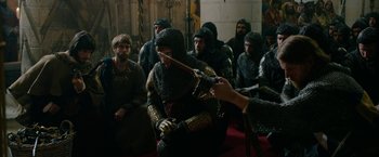 Movie still from “Outlaw King” (2018), directed by David Mackenzie – A group of people dressed in medieval clothing; Medium shot, Over the shoulder angle