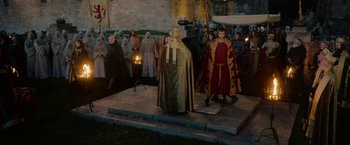 Movie still from “Outlaw King” (2018), directed by David Mackenzie – A group of people dressed in medieval costumes; Wide shot, High angle