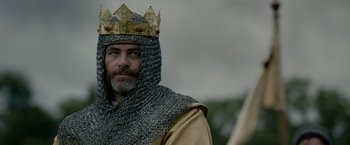 Movie still from “Outlaw King” (2018), directed by David Mackenzie – A man wearing a chain mail and a gold crown; Medium shot, Low angle