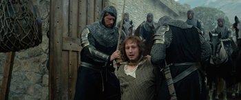 Movie still from “Outlaw King” (2018), directed by David Mackenzie – A group of men in chainmail and medieval garb; Medium shot, High angle