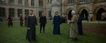 Movie still from “Outlaw King” (2018), directed by David Mackenzie – A group of people standing in a field; Wide shot, Over the shoulder angle