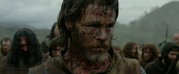 Movie still from “Outlaw King” (2018), directed by David Mackenzie – A person with blood on his face; Close Up shot, Low angle