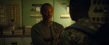 Movie still from “Outside the Wire” (2021), directed by Mikael Håfström – A man talking to another man in a military uniform; Close Up shot, Over the shoulder angle