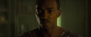 Movie still from “Outside the Wire” (2021), directed by Mikael Håfström – A man's face in a dark room; Close Up shot, Low angle