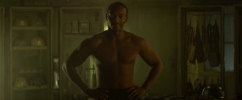 Movie still from “Outside the Wire” (2021), directed by Mikael Håfström – A man standing with his hands on his hips; Medium shot, Low angle