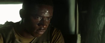 Movie still from “Outside the Wire” (2021), directed by Mikael Håfström – A person looking at the camera; Close Up shot, Over the shoulder angle