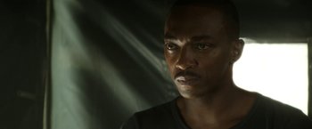 Movie still from “Outside the Wire” (2021), directed by Mikael Håfström – A man's face in the dark; Close Up shot, Low angle