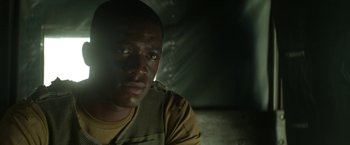 Movie still from “Outside the Wire” (2021), directed by Mikael Håfström – A man in a military uniform looking at the camera; Close Up shot, Low angle