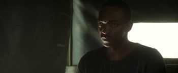 Movie still from “Outside the Wire” (2021), directed by Mikael Håfström – A person in a dark room; Close Up shot, Low angle