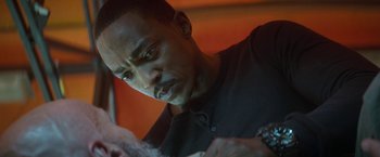 Movie still from “Outside the Wire” (2021), directed by Mikael Håfström – A person with a tattoo on his arm; Close Up shot, Over the shoulder angle