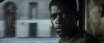 Movie still from “Outside the Wire” (2021), directed by Mikael Håfström – A person looking out of a window; Close Up shot, Over the shoulder angle