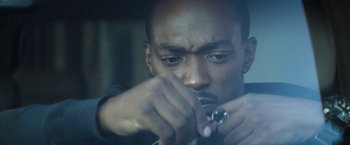 Movie still from “Outside the Wire” (2021), directed by Mikael Håfström – A man holding a screwdriver in his hand; Extreme Close Up shot, High angle
