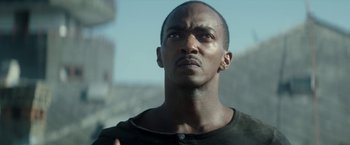 Movie still from “Outside the Wire” (2021), directed by Mikael Håfström – A person looking up at the sky; Close Up shot, Low angle