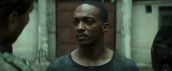 Movie still from “Outside the Wire” (2021), directed by Mikael Håfström – A person wearing a black shirt; Close Up shot, Low angle