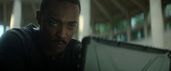 Movie still from “Outside the Wire” (2021), directed by Mikael Håfström – A man's face as he looks at the camera; Close Up shot, Low angle