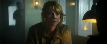 Movie still from “Outside the Wire” (2021), directed by Mikael Håfström – A woman sitting in front of a window; Close Up shot, Low angle