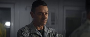 Movie still from “Outside the Wire” (2021), directed by Mikael Håfström – A person wearing a military uniform; Close Up shot, Over the shoulder angle