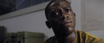 Movie still from “Outside the Wire” (2021), directed by Mikael Håfström – A person looking up at the sky; Close Up shot, Low angle