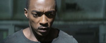 Movie still from “Outside the Wire” (2021), directed by Mikael Håfström – A man's face in the dark; Close Up shot, High angle