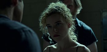 Movie still from “Ozark” (2017), created by Bill Dubuque – A woman with curly blonde hair is looking at the camera; Close Up shot, Over the shoulder angle