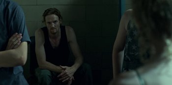 Movie still from “Ozark” (2017), created by Bill Dubuque – A man and a woman sitting next to each other in a dark room; Medium shot, Over the shoulder angle