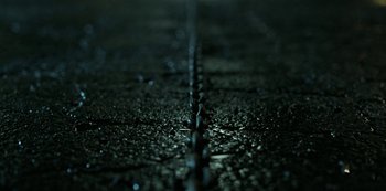 Movie still from “Ozark” (2017), created by Bill Dubuque – View of a road that has been paved with asphalt; Extreme Close Up shot, Overhead angle
