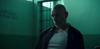 Movie still from “Ozark” (2017), created by Bill Dubuque – A bald man in a white t - shirt and a black jacket; Close Up shot, Low angle