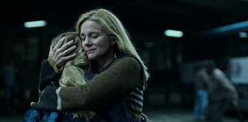 Movie still from “Ozark” (2017), created by Bill Dubuque – A woman hugging another woman with her eyes closed; Medium shot, Low angle