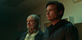 Movie still from “Ozark” (2017), created by Bill Dubuque – Two men standing next to each other in front of a wall; Close Up shot, Over the shoulder angle