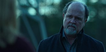 Movie still from “Ozark” (2017), created by Bill Dubuque – A man with a beard and a jacket on; Close Up shot, Low angle