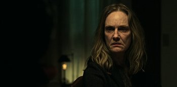 Movie still from “Ozark” (2017), created by Bill Dubuque – A woman with long blonde hair is looking at the camera; Close Up shot, Over the shoulder angle