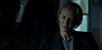 Movie still from “Ozark” (2017), created by Bill Dubuque – A woman in a black jacket talking on a phone; Close Up shot, Over the shoulder angle