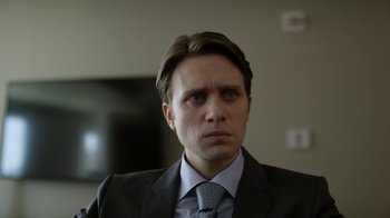 Movie still from “Mr. Robot” (2015), created by Sam Esmail – A person wearing a suit and tie; Close Up shot, Over the shoulder angle