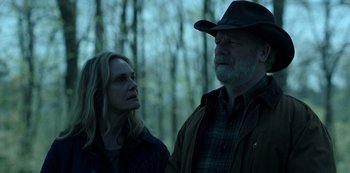 Movie still from “Ozark” (2017), created by Bill Dubuque – A man and a woman standing next to each other in the woods; Medium shot, Over the shoulder angle