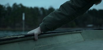 Movie still from “Ozark” (2017), created by Bill Dubuque – A person's hand on the side of a boat in a body of water; Extreme Close Up shot, High angle
