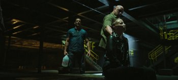 Movie still from “Ozark” (2017), created by Bill Dubuque – A group of people standing around in a dark room; Medium shot, High angle