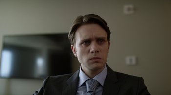 Movie still from “Mr. Robot” (2015), created by Sam Esmail – A person wearing a suit and tie; Close Up shot, Over the shoulder angle