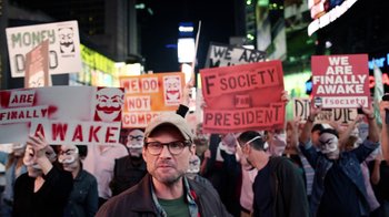 Movie still from “Mr. Robot” (2015), created by Sam Esmail – A crowd of people holding up signs in the street; Close Up shot, High angle
