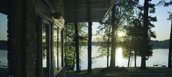 Movie still from “Ozark” (2017), created by Bill Dubuque – A view of a body of water from a porch; Extreme Wide shot, Low angle