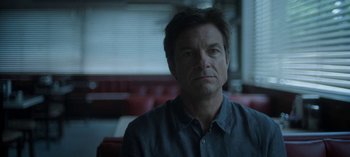 Movie still from “Ozark” (2017), created by Bill Dubuque – A person sitting in a chair; Close Up shot, Over the shoulder angle