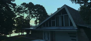 Movie still from “Ozark” (2017), created by Bill Dubuque – A house that has a lot of trees in the background; Extreme Wide shot, Low angle