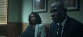 Movie still from “Ozark” (2017), created by Bill Dubuque – A man and a woman sitting next to each other in a room; Close Up shot, Low angle