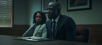 Movie still from “Ozark” (2017), created by Bill Dubuque – A man and a woman sitting in front of a table; Medium shot, Over the shoulder angle