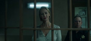 Movie still from “Ozark” (2017), created by Bill Dubuque – A woman standing behind bars in a jail cell; Close Up shot, Over the shoulder angle