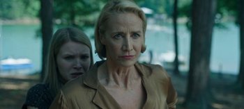 Movie still from “Ozark” (2017), created by Bill Dubuque – A woman with blonde hair and blue eyes standing next to another woman with blonde hair and blue eyes standing next to another woman; Close Up shot, Over the shoulder angle