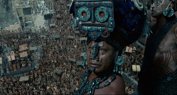 Movie still from “Apocalypto” (2006), directed by Mel Gibson – An image of a man in a crowd of people; Medium shot, Overhead angle