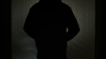 Movie still from “Mr. Robot” (2015), created by Sam Esmail – A person standing in front of a wall with their hands on their hips; Medium shot, Low angle