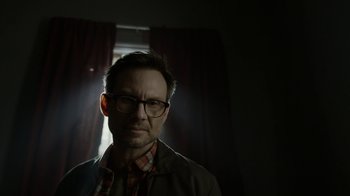 Movie still from “Mr. Robot” (2015), created by Sam Esmail – A man wearing glasses and a jacket in a dark room; Close Up shot, Low angle