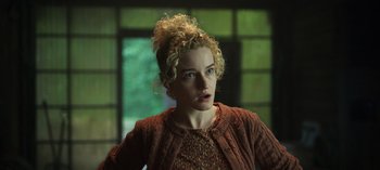 Movie still from “Ozark” (2017), created by Bill Dubuque – A woman with blonde curly hair wearing a red sweater; Close Up shot, Low angle