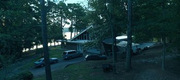 Movie still from “Ozark” (2017), created by Bill Dubuque – A van parked in front of a house next to trees; Extreme Wide shot, High angle